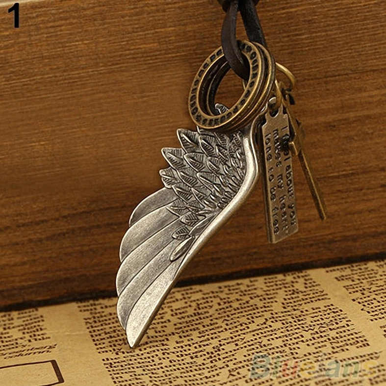 Dark aesthetic gothic angel wing leather necklace with cross symbol charm on brown leather cord, angled product photography