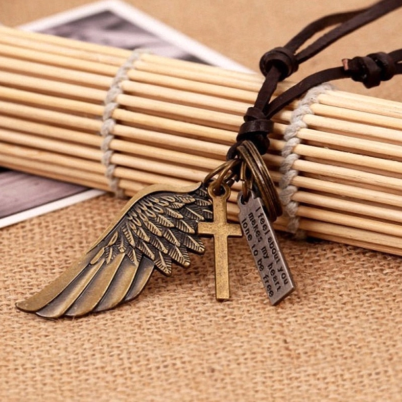 Victorian gothic style angel wing necklace with engraved metal charms on adjustable leather choker cord, product detail view