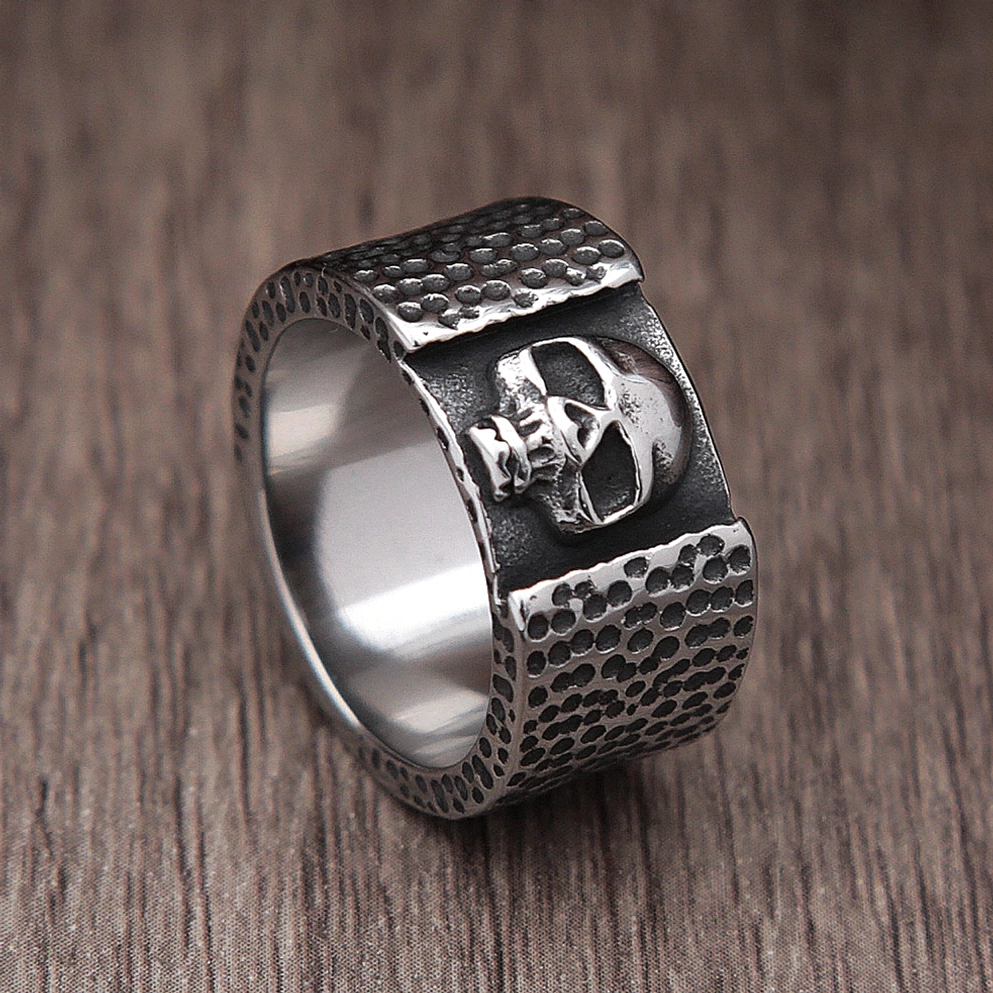 Profile skull stainless steel ring oblique view with polished inner band and side skull details hammered texture vintage tone