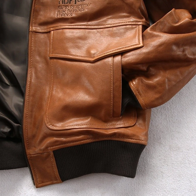 Lammleder Bomberjacke Brusttasche Nahaufnahme zeigt Flap-Design, Leder-Textur und gerippter Saum-Konstruktion – Premium Detail