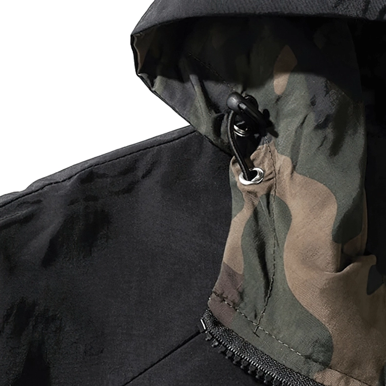Männliches Modell trägt Camouflage-Gothic-Military-Kapuzenpullover, zeigt Oversized-Passform und beiläufige Street-Ästhetik, Alternative-Dark-Fashion-Look, funktionales Design-Styling