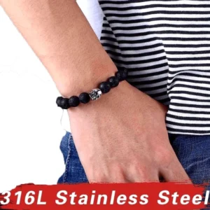 Unisex gothisches Lava-Stein-Totenkopf-Armband mit verstellbarer Schnürung an männlichem Handgelenk getragen, gepaart mit gestreiftem Casual-Shirt für alltägliche rebellische Styling