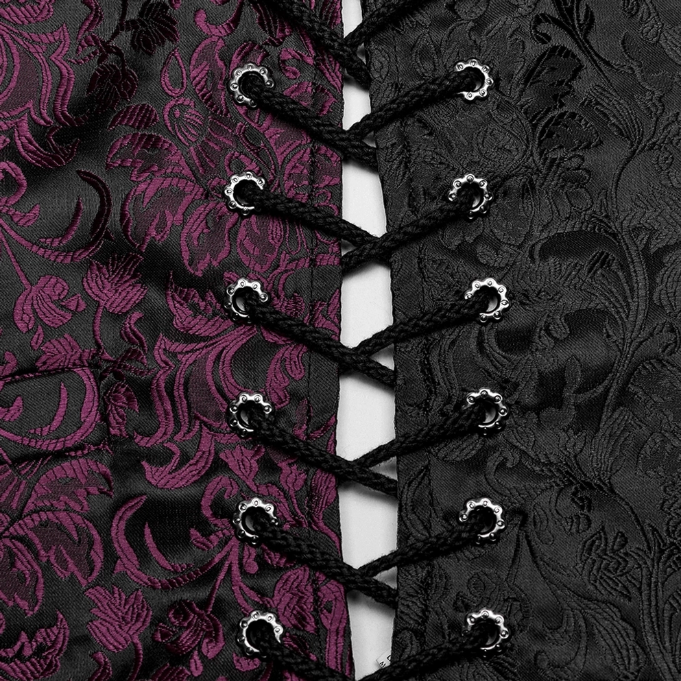Nahaufnahme der geflochtenen schwarzen Schnüre und ornaten Metallösen mit Jacquard-Blütenmuster im Hintergrund