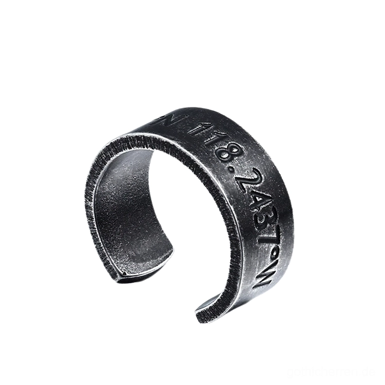Gothic Koordinaten-Engraving-Ring mit präzisions-eingravierter Inschrift (118.2437°W), mattiertes Vintage-Metallfinish, schräge Vorderansicht zeigt Details der fein gravierten Zahlen und Symbole, offene Manschetten-Konstruktion