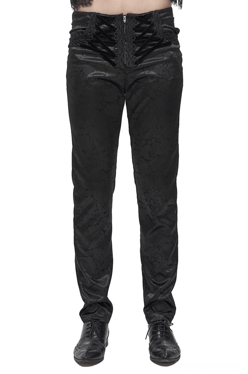 Schwarze Gothic-Cargohose mit Schnürung Vorderansicht – hochgeschnittene Silhouette mit ornamentaler Jacquard-Musterung und samtiger Schnürverschluss-Taille an männlichem Modell