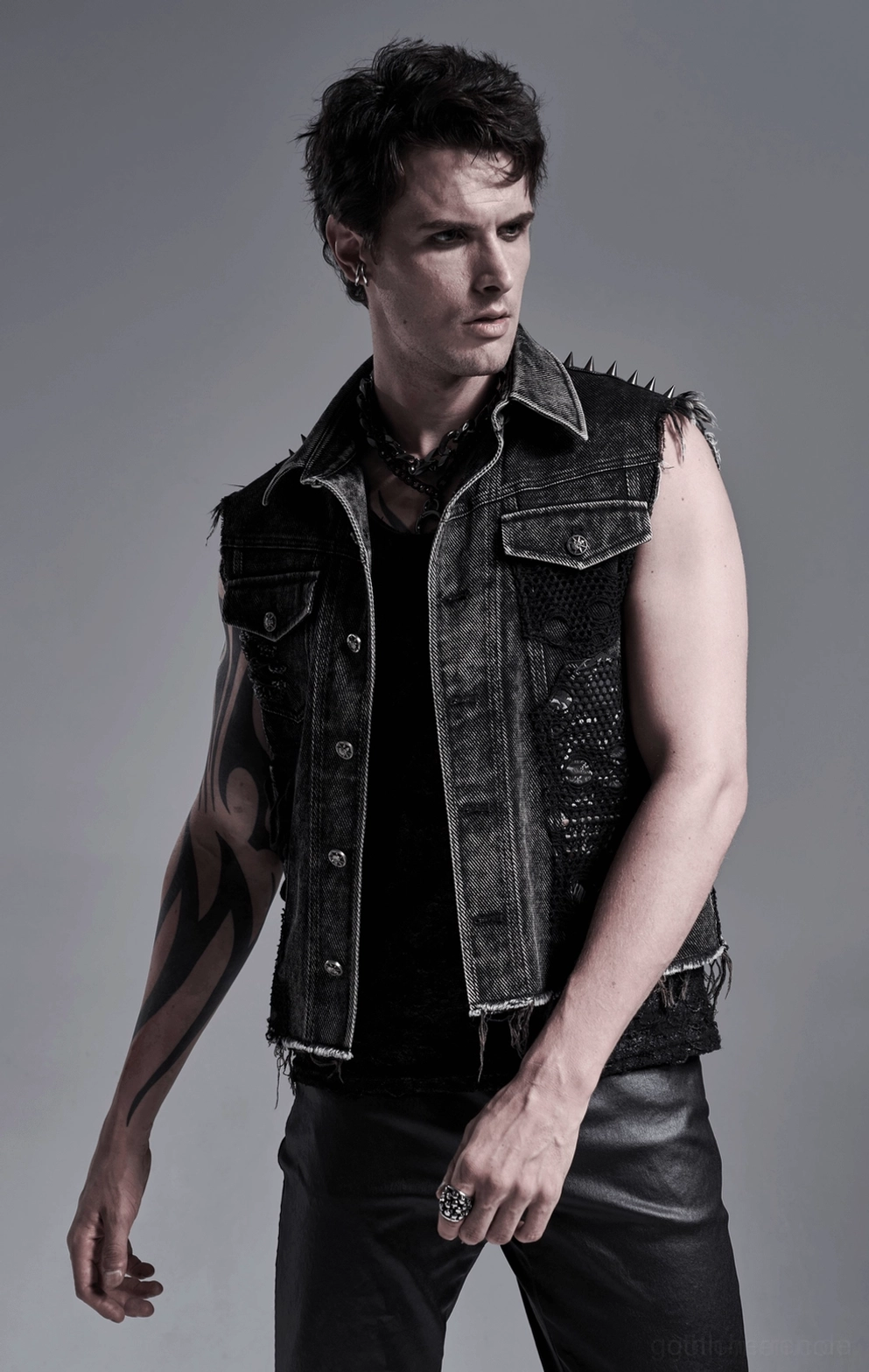 Schwarze Gothic Denim Weste auf Model - dreiviertelseitige Ansicht zeigt taillierte Silhouette und saure Wäsche Textur über schwarzem Tank