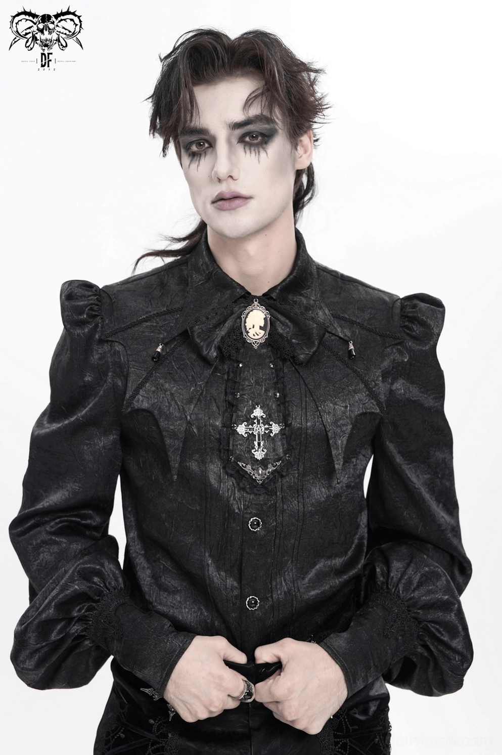 Schwarze gothic jabot krawatte auf modell mit kreuzanhänger, kamee-brosche und gesamtem dramatischem silhouetten-design
