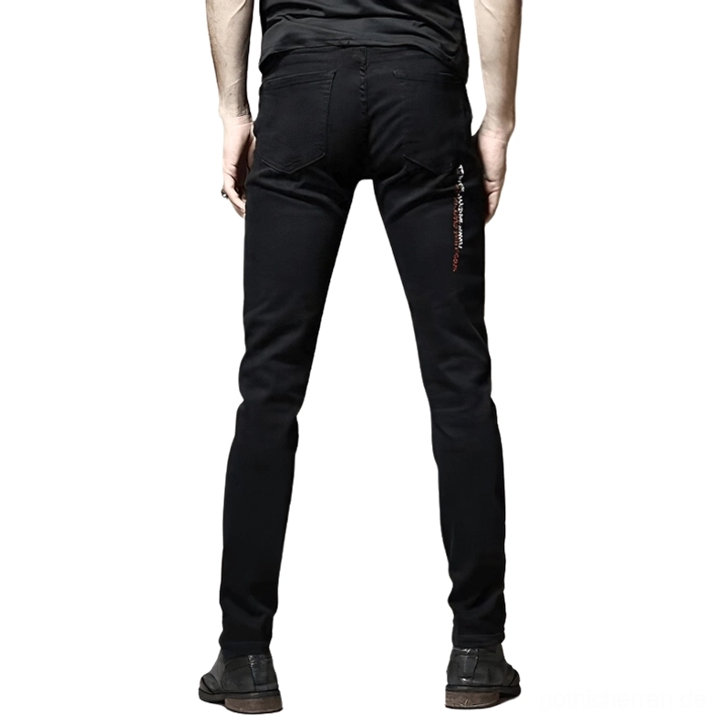 Schwarze Gothic-Slim-Jeans Rückansicht auf männlichem Model, zeigt subtile seitliche Graffiti-Drucke und Stickerei-Details an Seitennähten mit schlankem Slim-Fit Schnitt