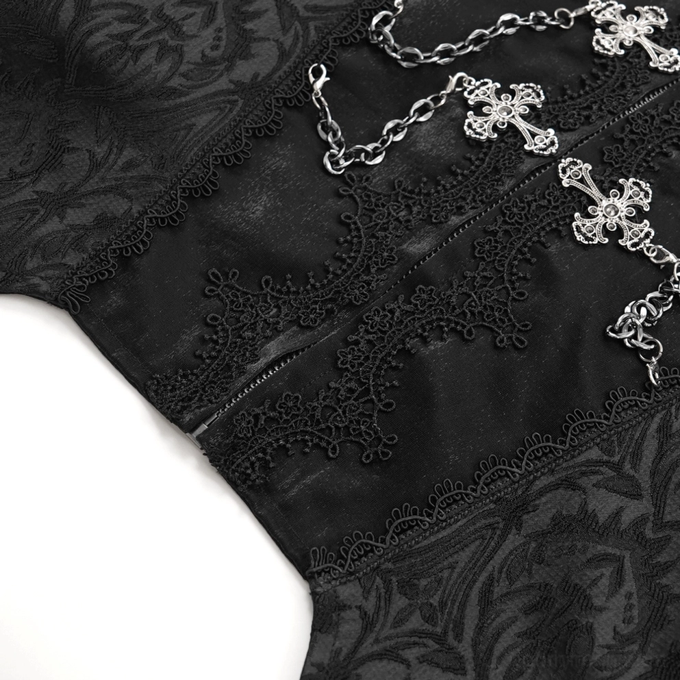 Abgewinkelte Nahaufnahme gotischer Weste mit Kreuzkettenornamenten und Spitzeneinfassungsdetails auf Jacquard-Textil