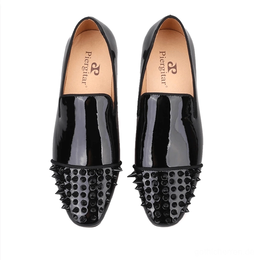 Draufsicht auf schwarze Lackleder Spike Loafer mit markierter Innensohle, geometrischen Spike-verzierte Zehenkappen und glänzendem Lederoberflächenfinish