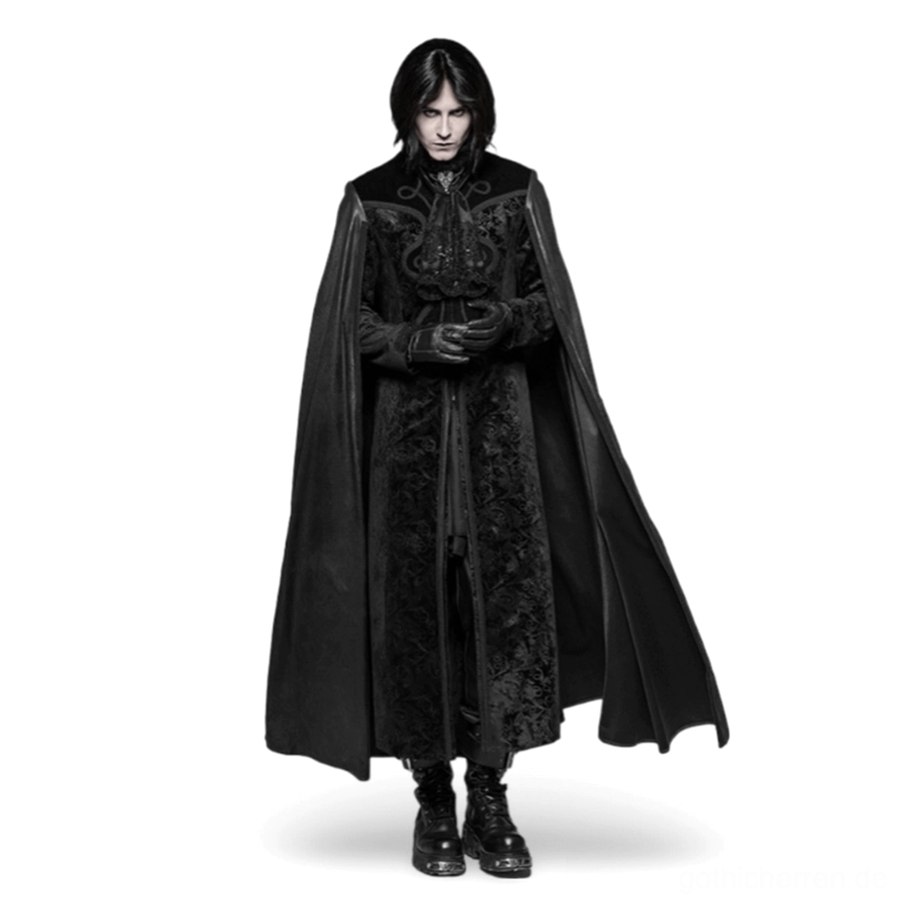 Schwarzer Samt-Herrenmantel mit geprägtem Paisley-Damast-Muster, Frontansicht auf männlichem Model, angenähtes fließendes Cape, verstellbarer Stehkragen mit Kreuzanhänger, Gothic-Mantel in Volllänge