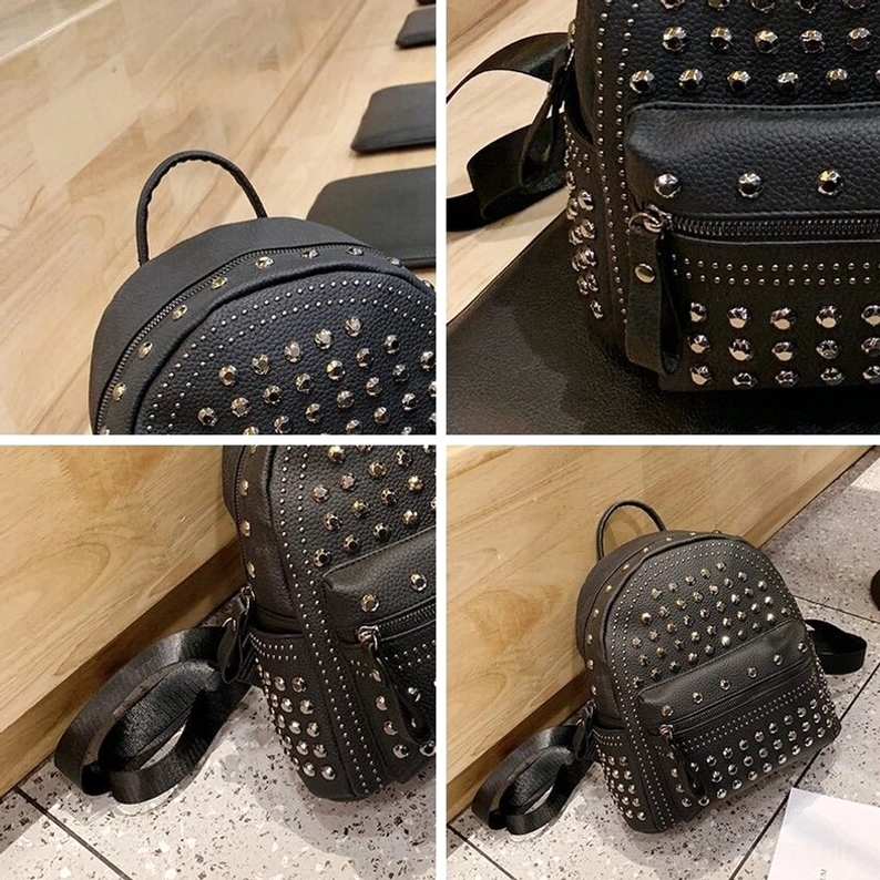Schwarzer Gothic Rucksack Draufsicht, fokussiert auf Tragegriff, oberes Nieten-Design und strukturierte Öffnung mit Metallbeschlag