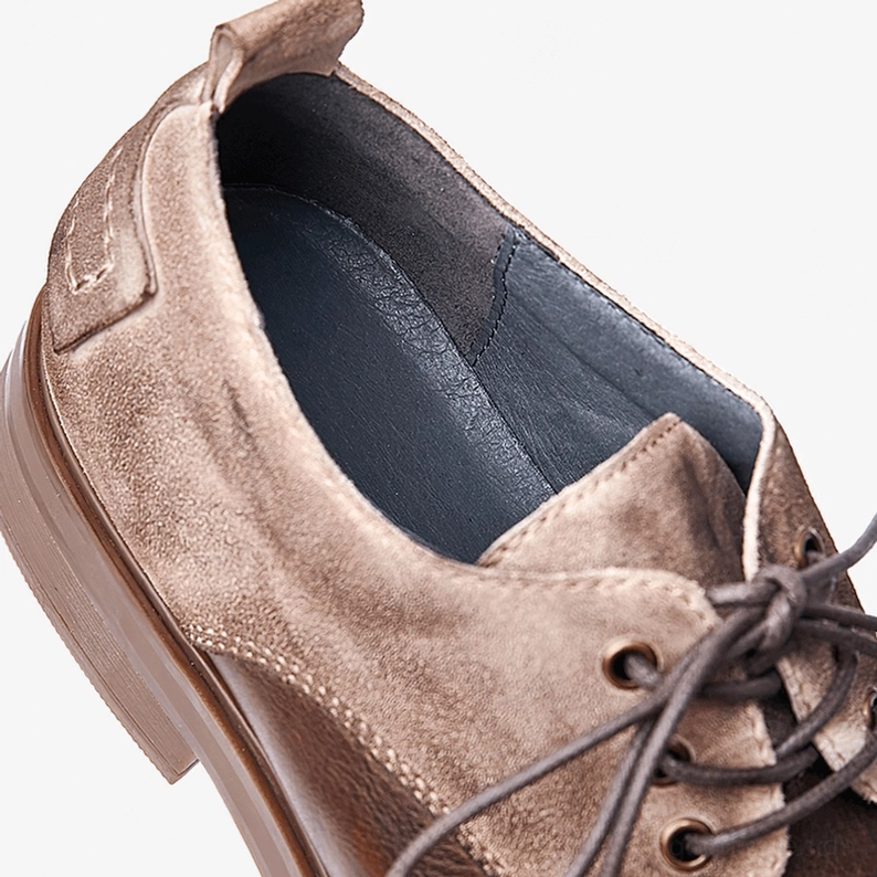 Pair of men's vintage-style dark leather lace-up gothic boots showcasing authentic craftsmanship, visible stitching detail, aged leather patina and traditional gothic bootmaking techniques
